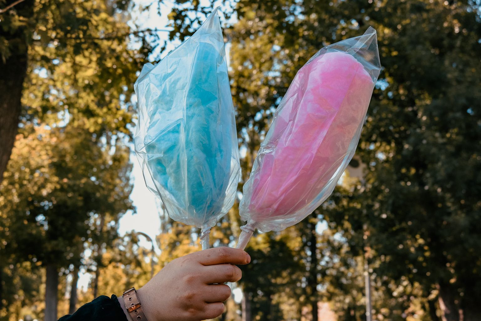 Fluffy pink and blue fairy floss on sticks at a party