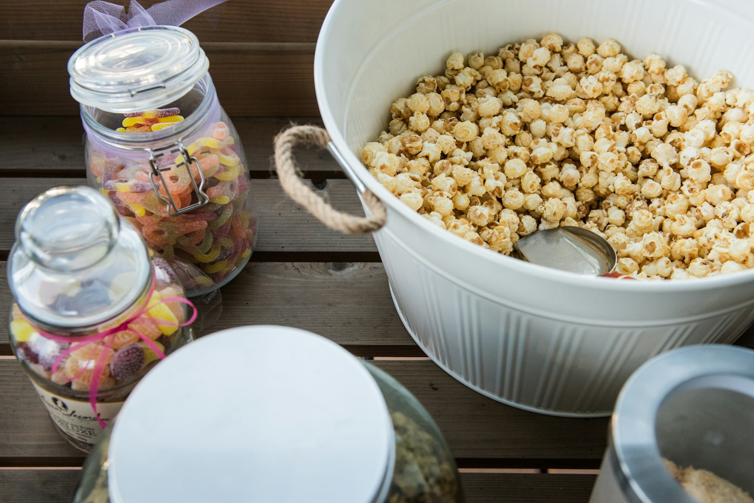 A warm tabletop of popcorn and treats arranged for gifting