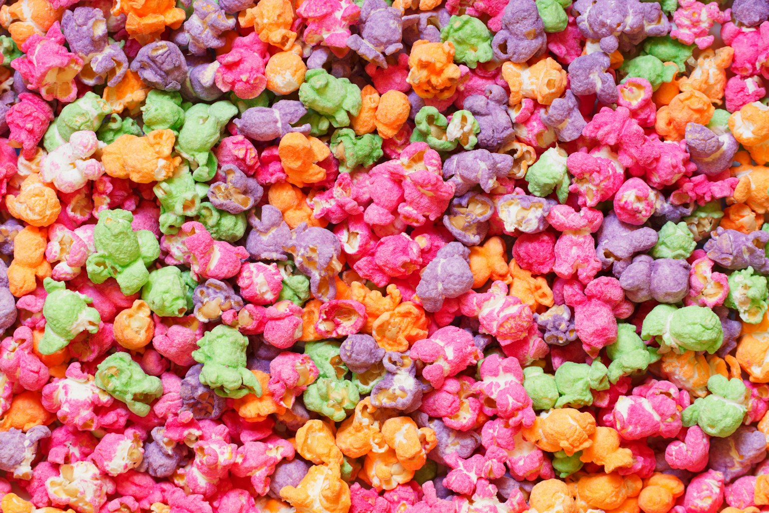 A close-up of rainbow popcorn, showing the bright coloured glaze on each piece